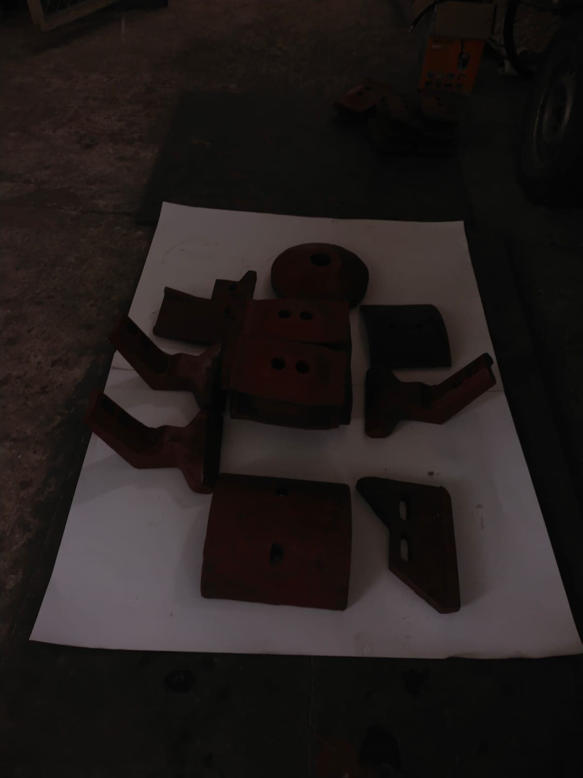 Industrial spare parts laid out on workshop floor