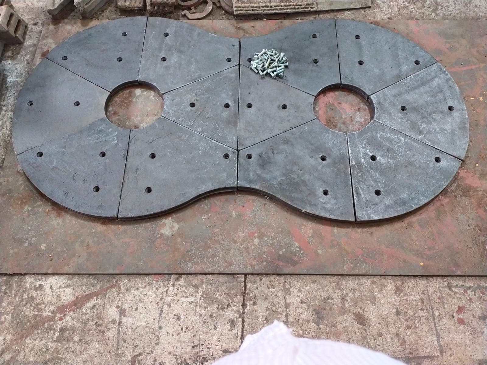 Custom-fabricated figure-eight steel liner assembly with bolts